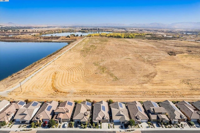 drone / aerial view with a water and mountain view