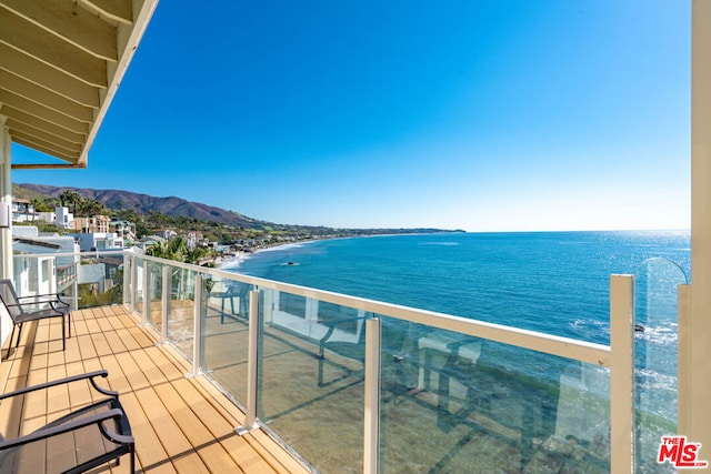 balcony with a water and mountain view