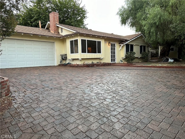 ranch-style house featuring a garage