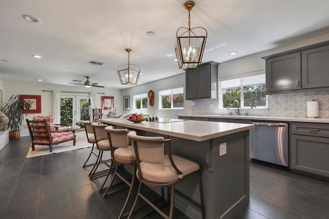 kitchen featuring dishwasher, dark hardwood / wood-style floors, plenty of natural light, and a kitchen island