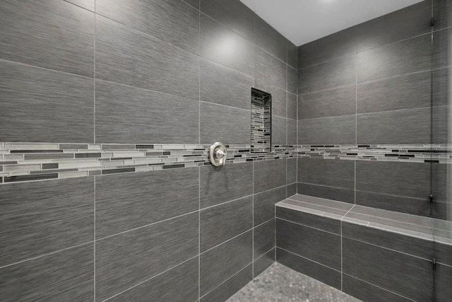 bathroom with a tile shower