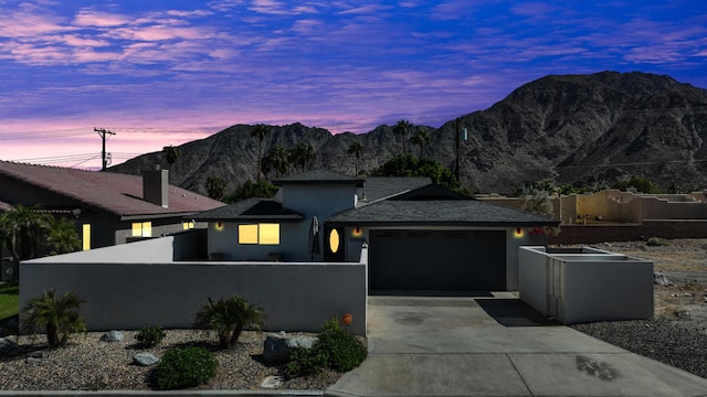 view of front of house with a mountain view and a garage