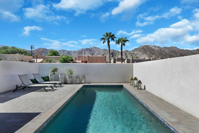 view of swimming pool featuring a mountain view and a patio area