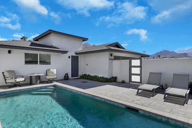 back of house with a patio and a mountain view