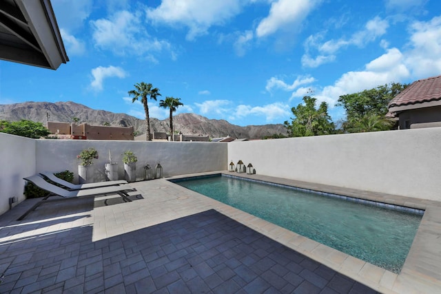 view of pool featuring a patio area and a mountain view