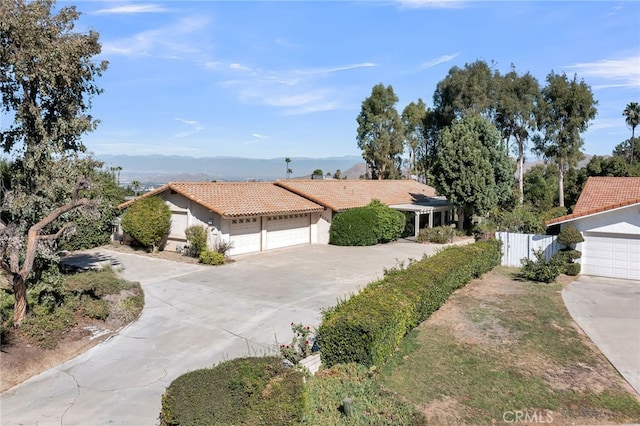 view of front of house with a garage and a mountain view