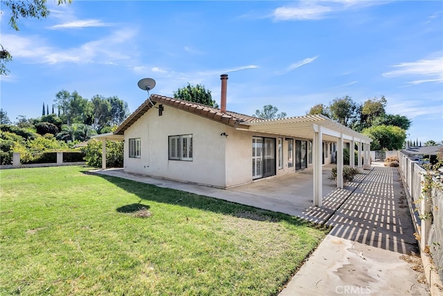 back of house with a patio area, a yard, and a pergola