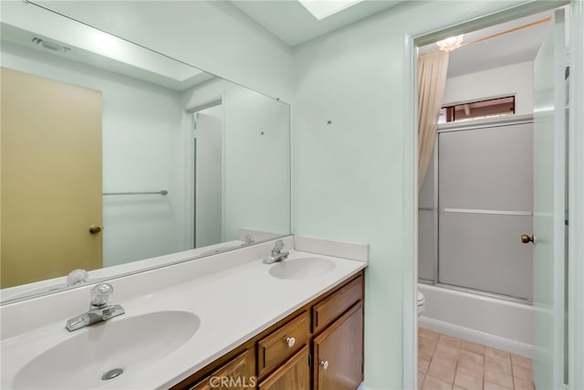 full bathroom featuring vanity, toilet, tile patterned floors, and shower / bath combination with glass door