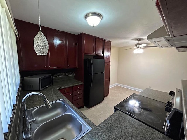 kitchen featuring black fridge, range with electric cooktop, sink, pendant lighting, and ceiling fan