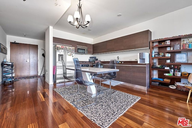 dining room with a chandelier and dark wood-type flooring