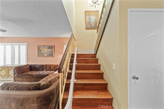 stairs featuring a textured ceiling