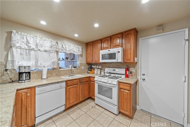 kitchen featuring sink, tasteful backsplash, and white appliances