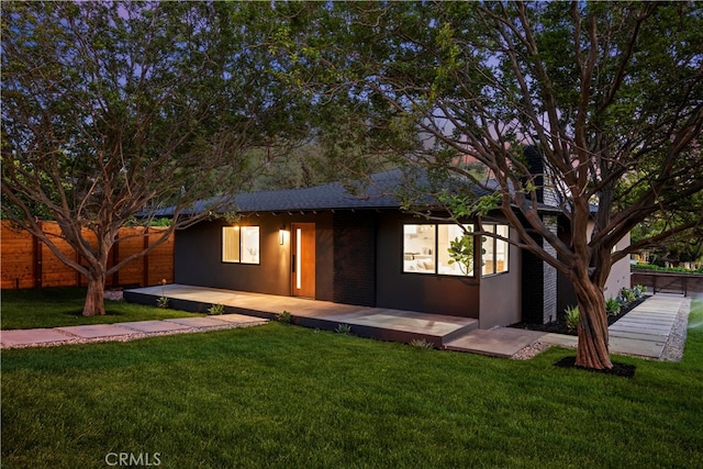 view of front facade with a patio area and a front yard