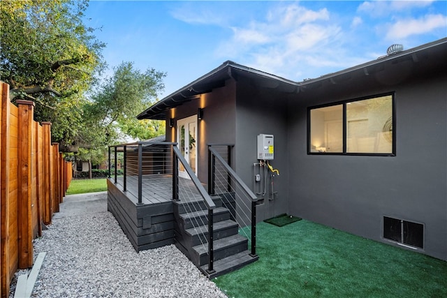 view of side of property featuring a wooden deck and a yard