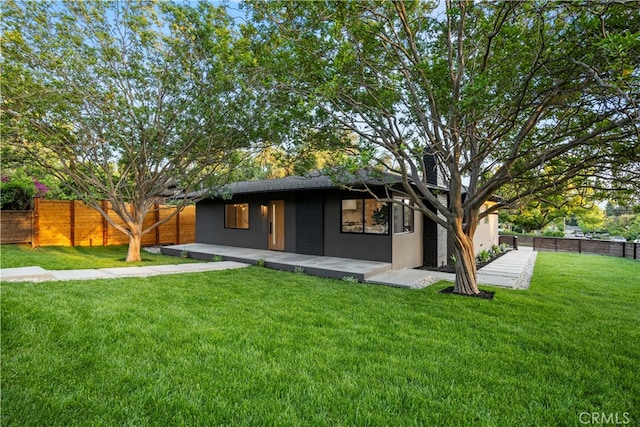 rear view of property featuring a yard