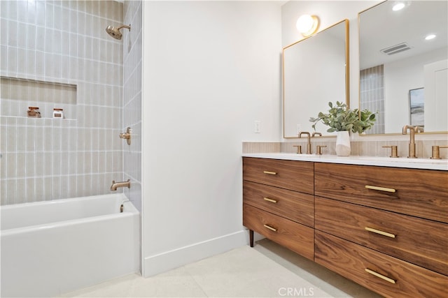 bathroom with vanity and tiled shower / bath