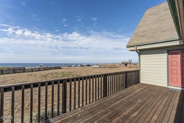 wooden terrace featuring a water view