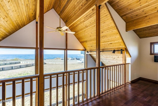 interior space featuring dark wood-type flooring, beamed ceiling, high vaulted ceiling, a water view, and wood ceiling