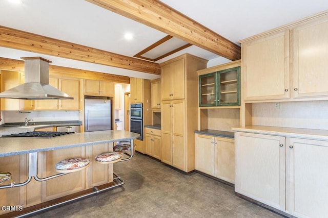 kitchen with wall chimney exhaust hood, light brown cabinets, beam ceiling, and appliances with stainless steel finishes