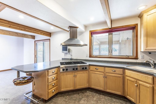 kitchen featuring kitchen peninsula, wall chimney exhaust hood, sink, beamed ceiling, and stainless steel gas stovetop