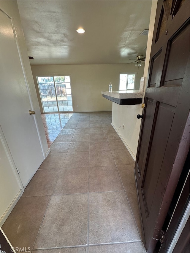 hallway with light tile patterned floors