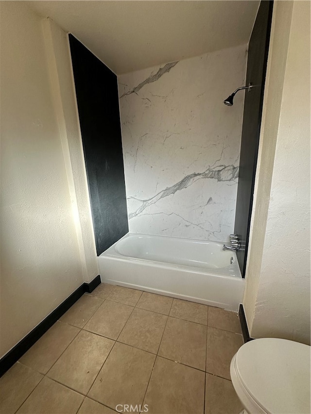 bathroom featuring toilet, tiled shower / bath combo, and tile patterned floors