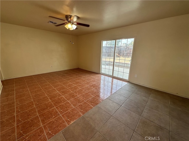 empty room featuring tile patterned floors and ceiling fan