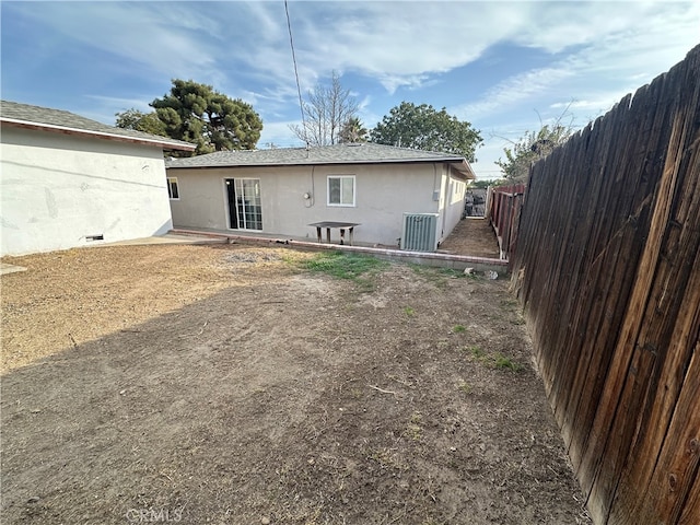 rear view of property with cooling unit