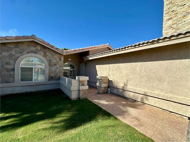 view of property exterior featuring a lawn