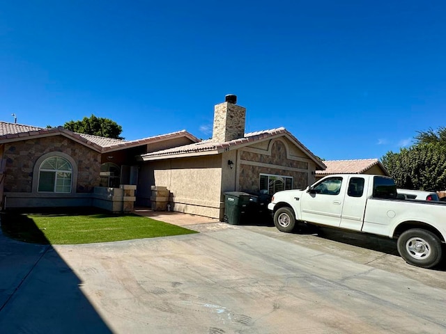 view of side of home with a lawn