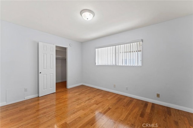 unfurnished bedroom featuring light hardwood / wood-style floors and a closet