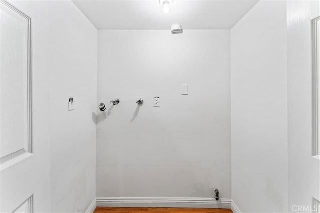 laundry room featuring washer hookup and hardwood / wood-style flooring