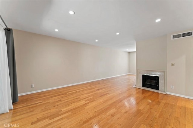 unfurnished living room with light wood-type flooring