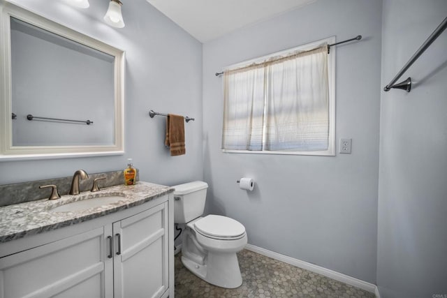 bathroom with vanity, toilet, and tile patterned flooring