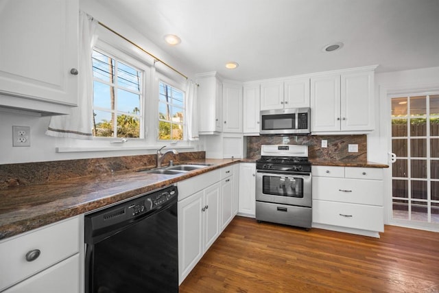 kitchen with sink, white cabinets, stainless steel appliances, and dark hardwood / wood-style flooring