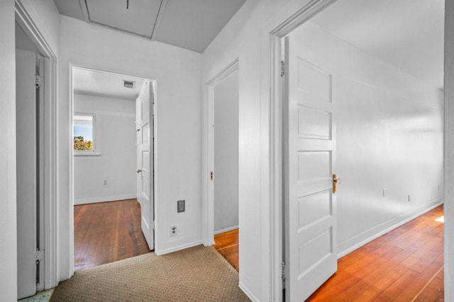 corridor with hardwood / wood-style floors