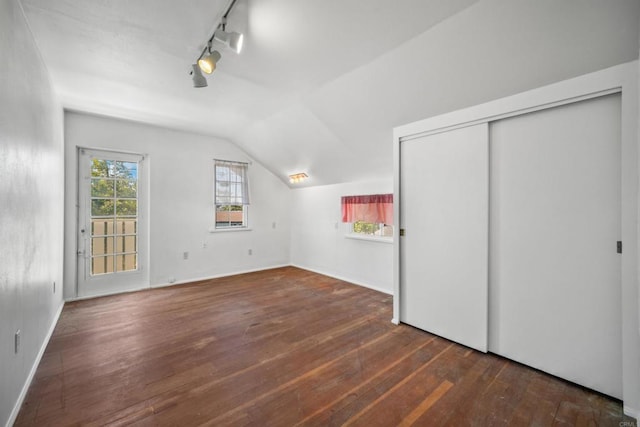 bonus room with lofted ceiling and dark hardwood / wood-style floors