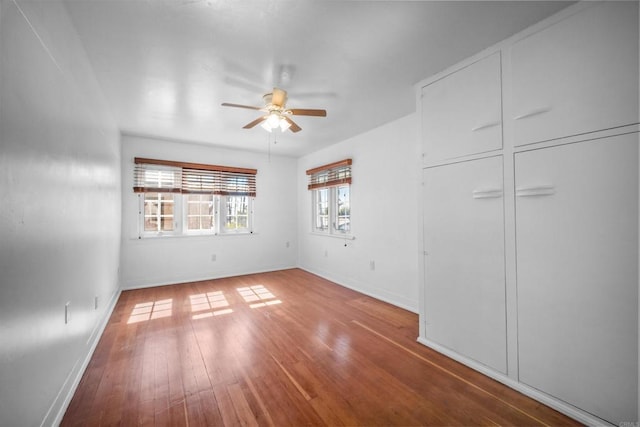 unfurnished bedroom featuring wood-type flooring and ceiling fan