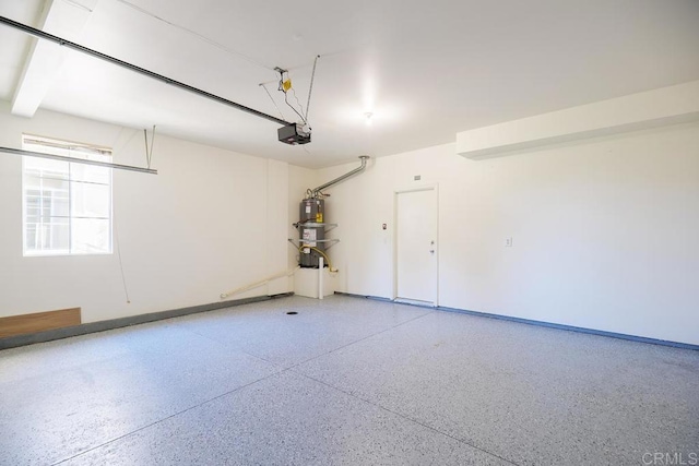 garage featuring secured water heater and a garage door opener