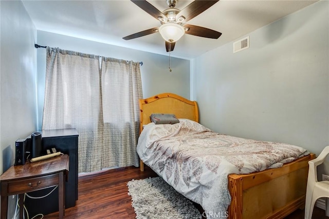 bedroom with dark hardwood / wood-style floors and ceiling fan