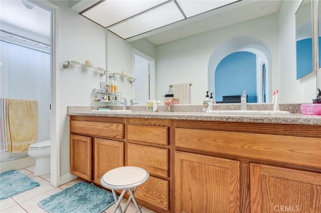 bathroom with tile patterned flooring, vanity, a shower with shower curtain, and toilet