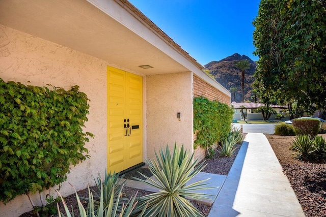 view of exterior entry with a mountain view