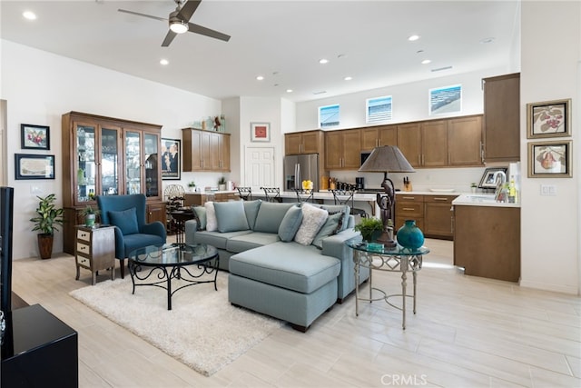 living room featuring a wealth of natural light and ceiling fan