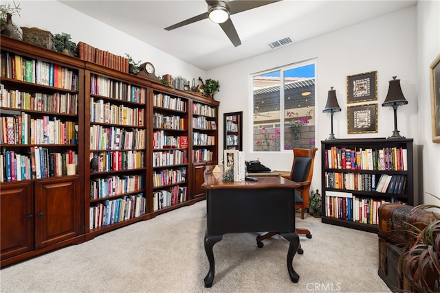 carpeted office with ceiling fan