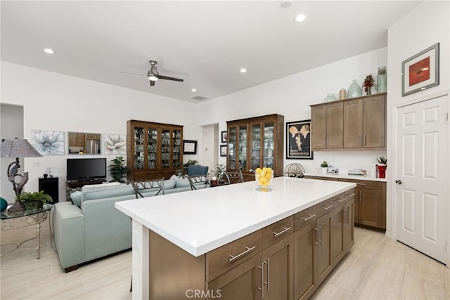 kitchen featuring ceiling fan and a center island