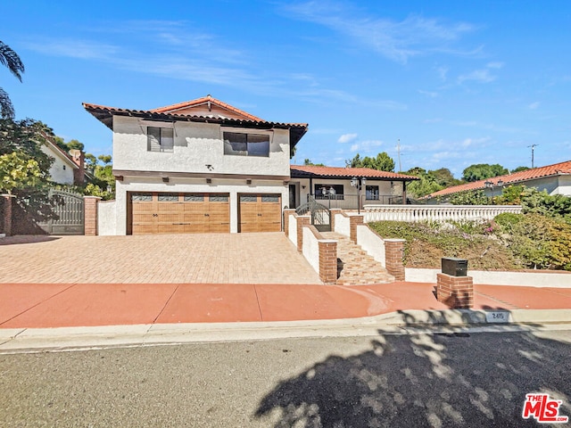 mediterranean / spanish house with a garage