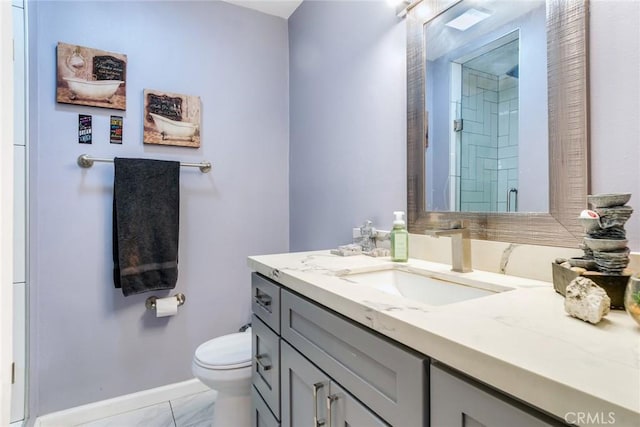 bathroom with toilet, vanity, and an enclosed shower