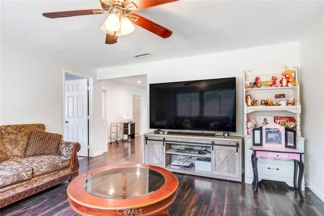 living room with ceiling fan and dark hardwood / wood-style flooring