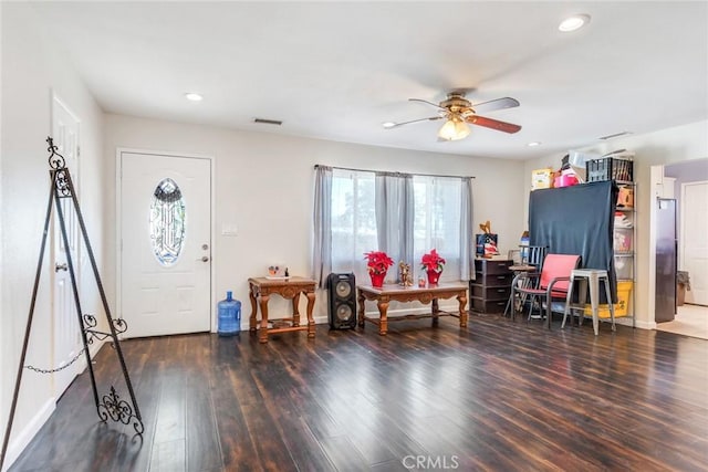 foyer with dark wood-type flooring and ceiling fan