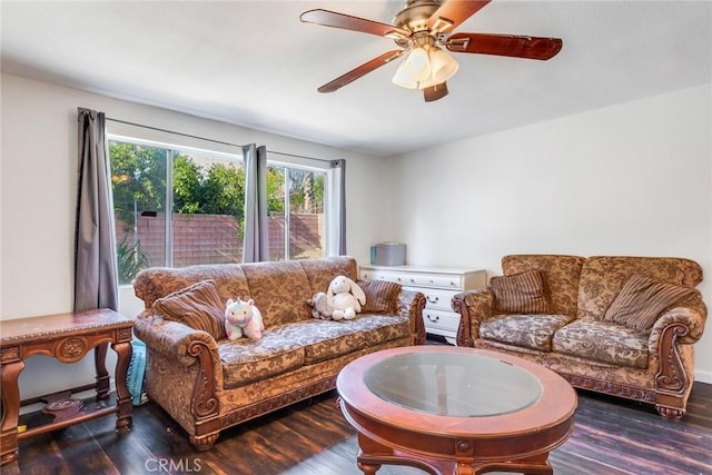 living room featuring ceiling fan and dark hardwood / wood-style flooring